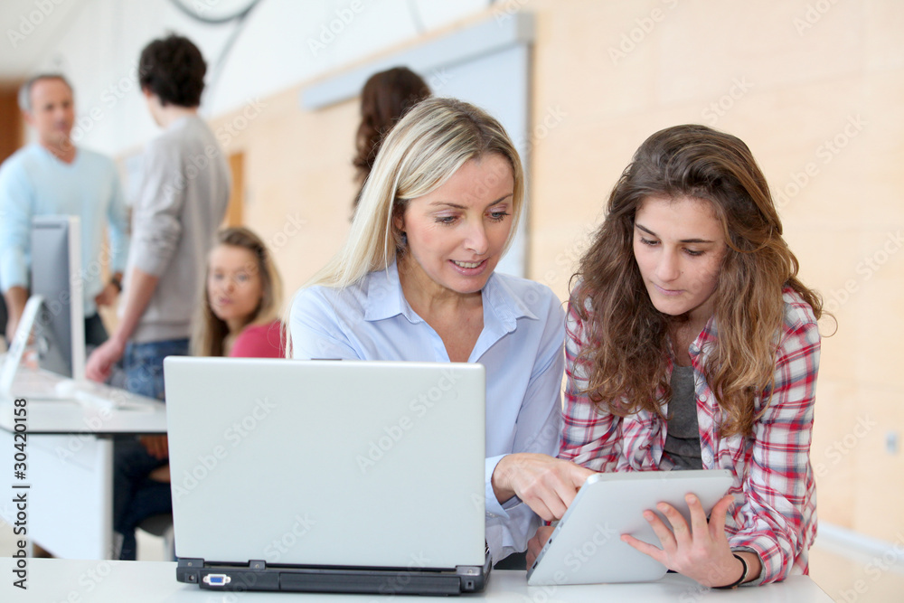 Portrait of teacher and teenage girl in computing class Portrait of teacher and teenage girl in computing class