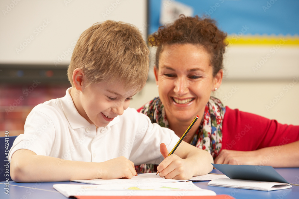 Schoolboy Studying In Classroom With Teacher Schoolboy Studying In Classroom With Teacher