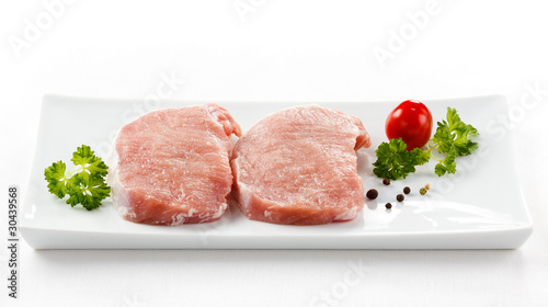 Fresh raw pork on white plate