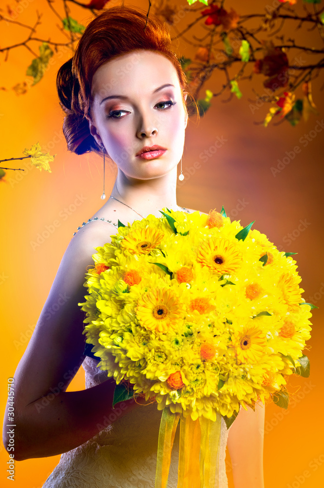 Gorgeous young redhead woman with bouquet of flowers
