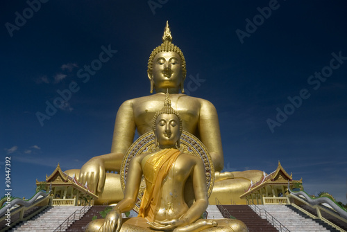 Double golden Buddha in outdoor.
