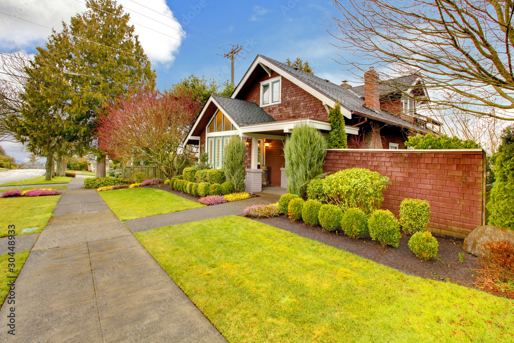 Spring exterior house with brown siding Spring exterior house with brown siding