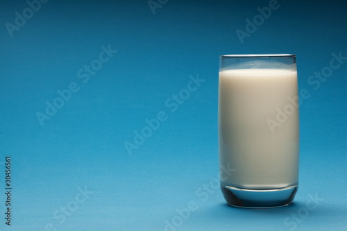 Glass of milk on a blue