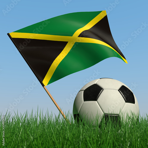 Soccer ball in the grass and the flag of Jamaica photo