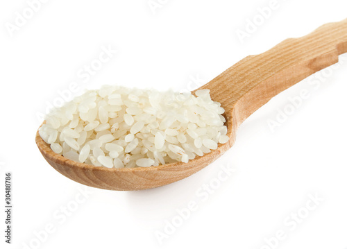 rice in wooden spoon isolated on white