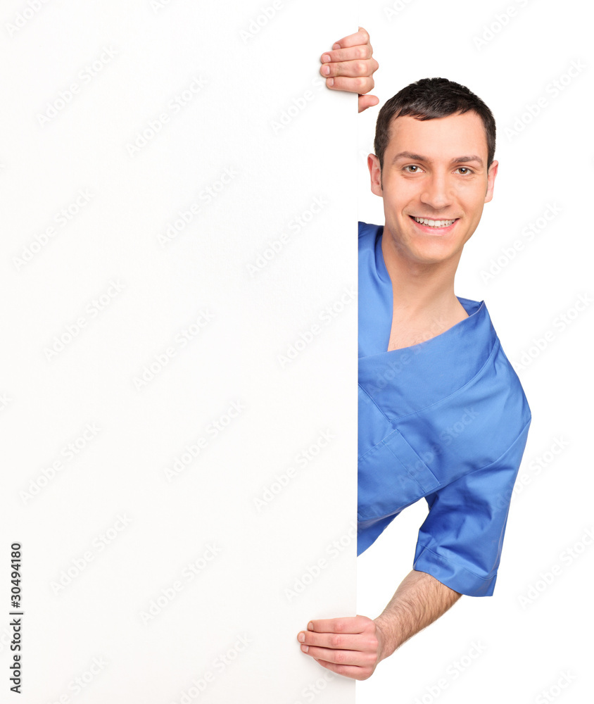 Young medical doctor holding a blank billboard Young medical doctor holding a blank billboard