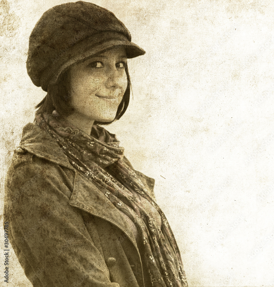 Fototapeta premium Fashion girl in cap. Photo in old image style.