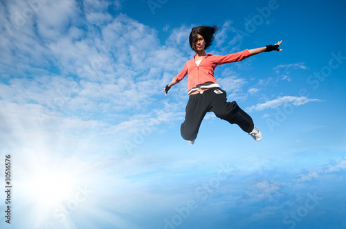 sport woman jumping and fly over sky and sun