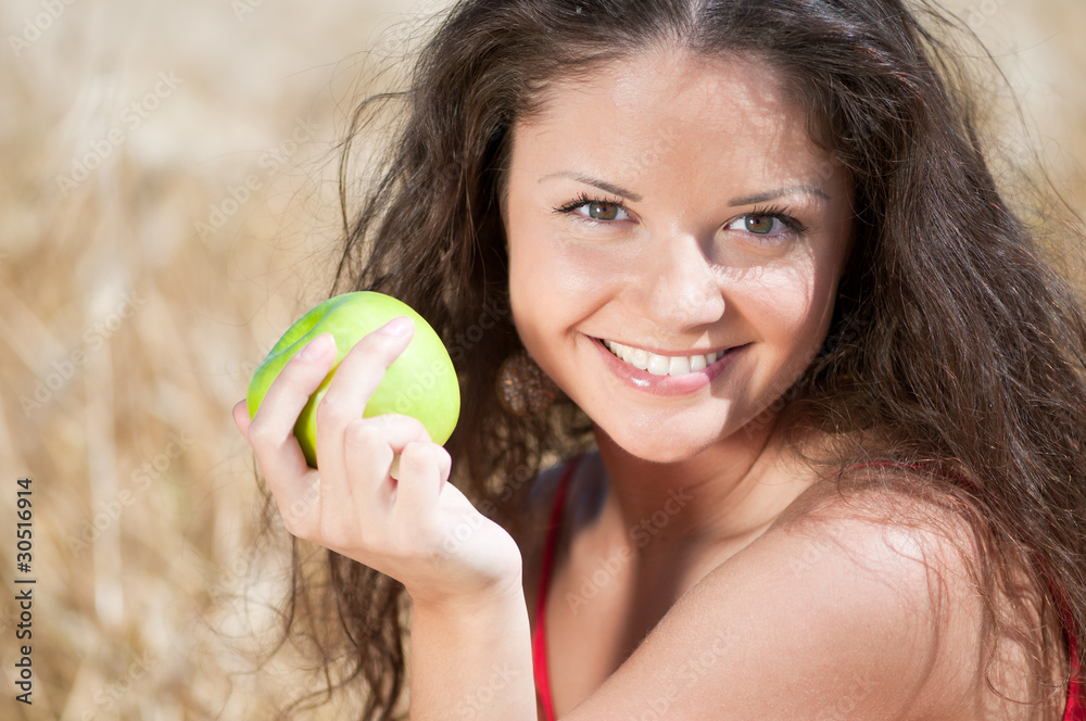 Perfect woman eating apple in dield. Summer picnic. Perfect woman eating apple in dield. Summer picnic.
