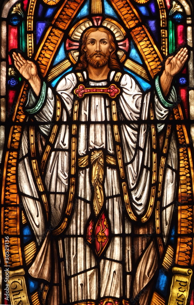Stained Glass window of Jesus holding his hands up