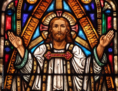 Stained Glass window of Jesus with his hands up