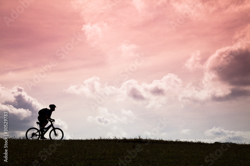 The Silhouette of mountain bike rider and sunset