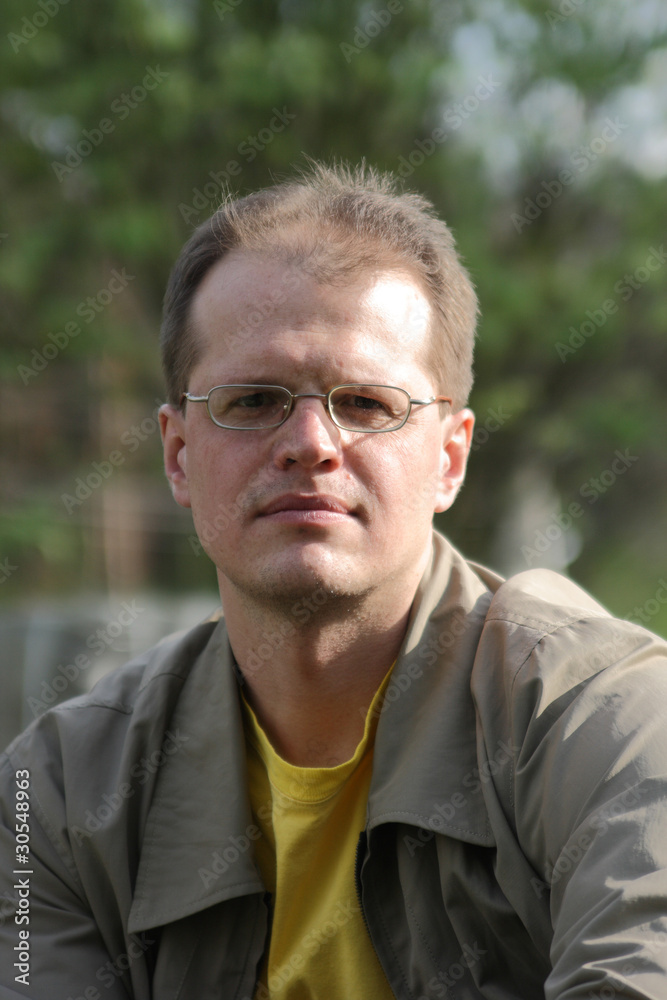 The man close up wearing spectacles The man close up wearing spectacles