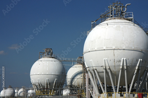 white tanks of big crude oil refinery