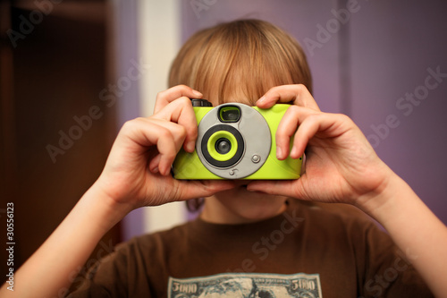 Boy with photo point-n-shoot film camera photo