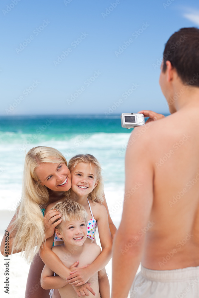 Man taking a photo of his family Man taking a photo of his family