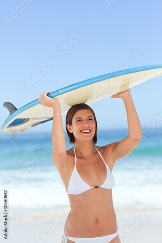 Pretty woman with her surfboard