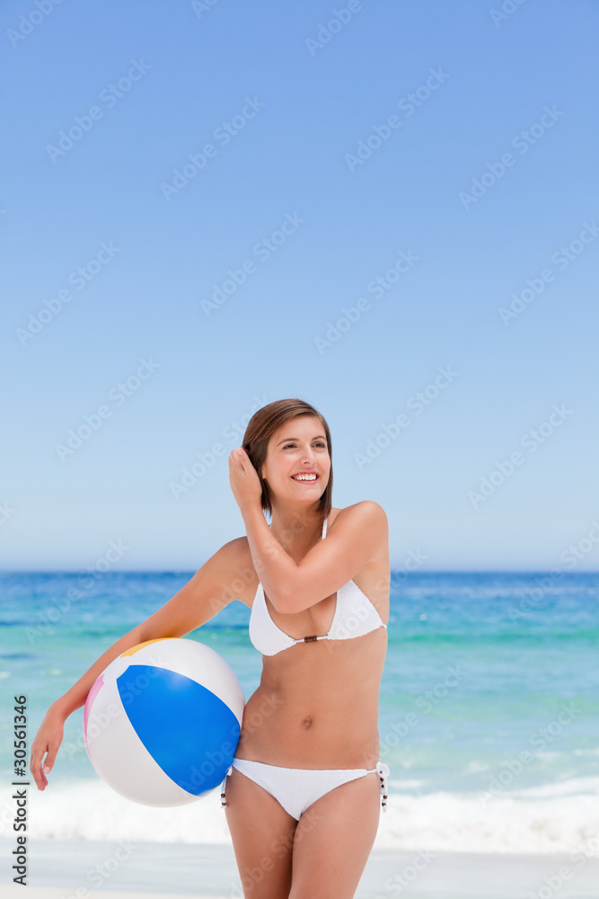 Cute woman with her ball on the beach