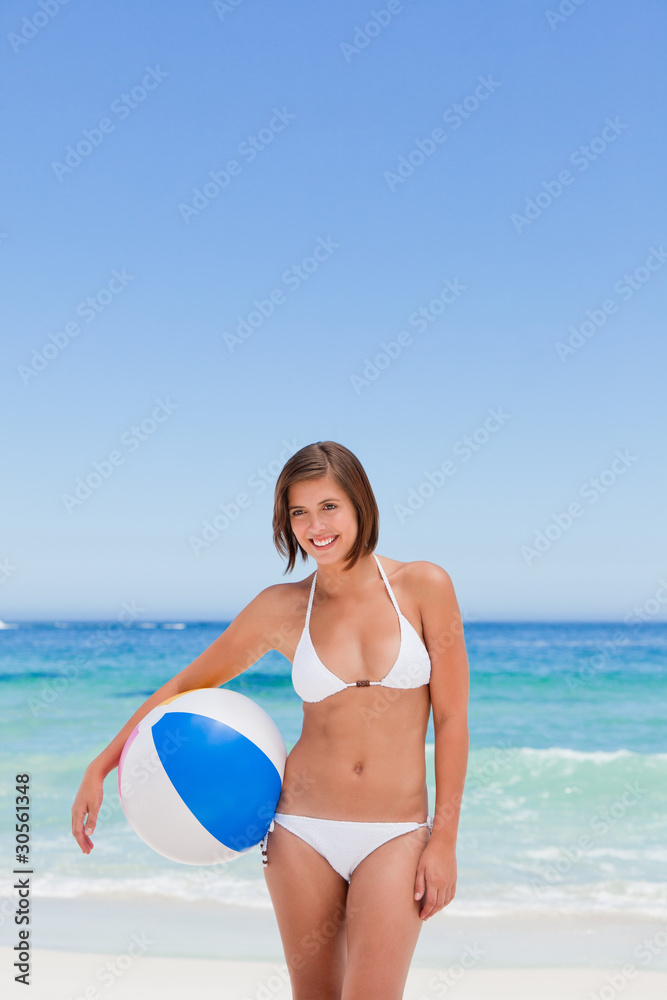 Cute woman with her ball on the beach