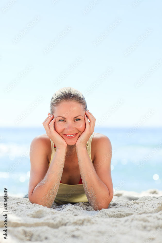 Lovely woman sunbathing at the beach Lovely woman sunbathing at the beach