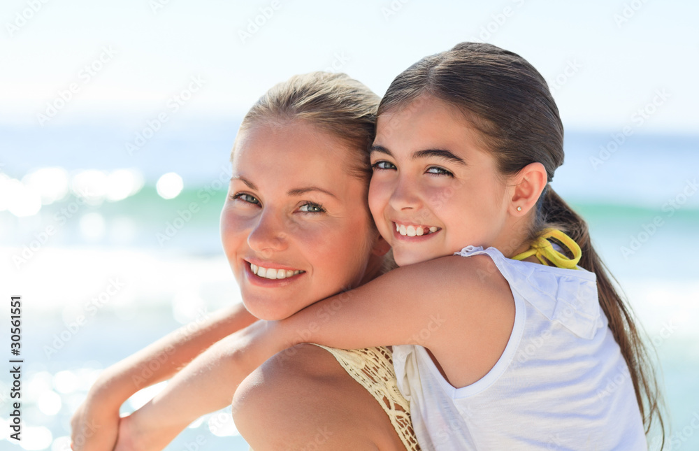 Mother having daughter a piggyback at the beach Mother having daughter a piggyback at the beach