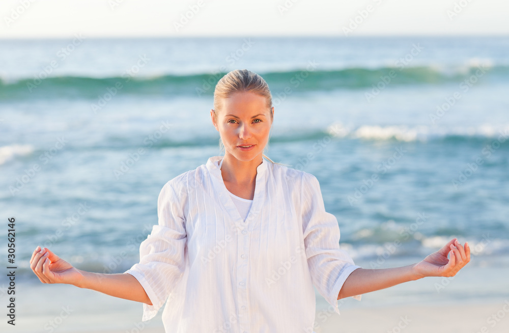 Active woman practicing yoga on the beach Active woman practicing yoga on the beach