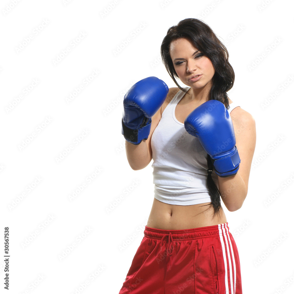 A young and sexy aggresive femal boxer in blue gloves