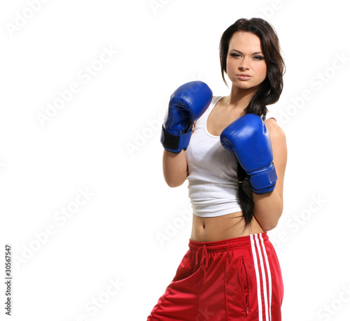 A young and sexy aggresive femal boxer in blue gloves © Acronym