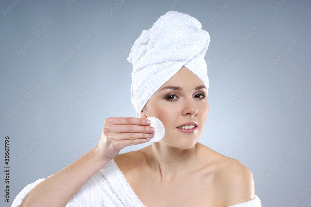 A young and sexy Caucasian woman is pampering her face A young and sexy Caucasian woman is pampering her face