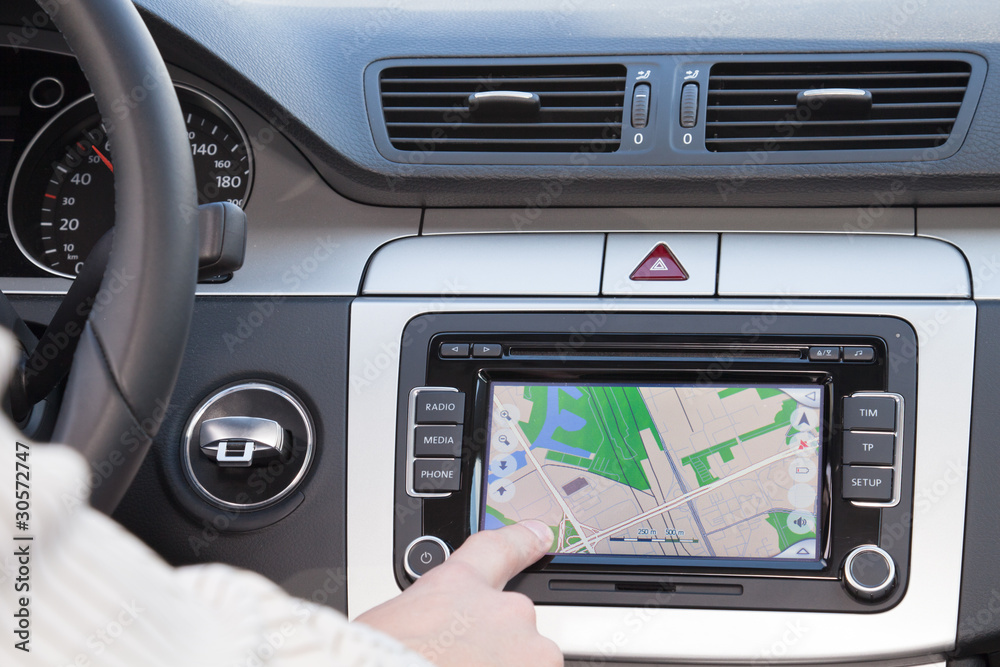 GPS navagation in modern car. Finger pointing destination.