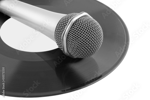 Microphone laying on vinyl records isolated photo