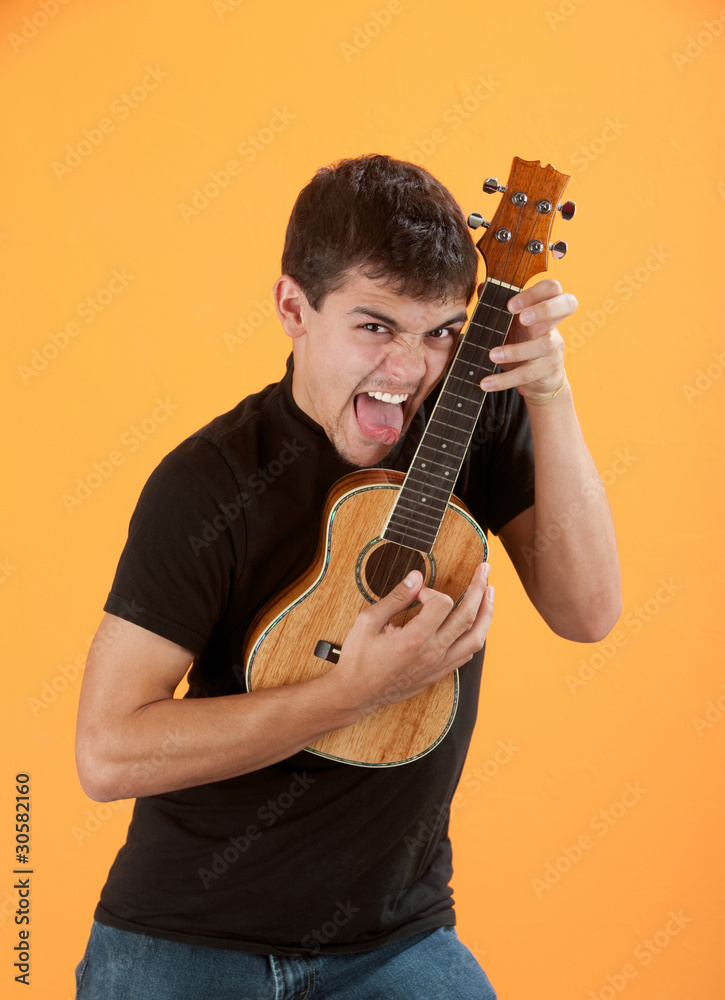 Naklejka premium Young ukulele player