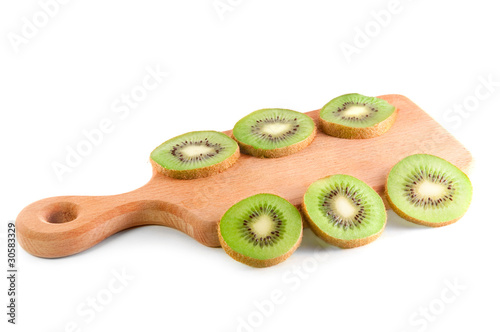 slices of kiwi on the cutting board  over white