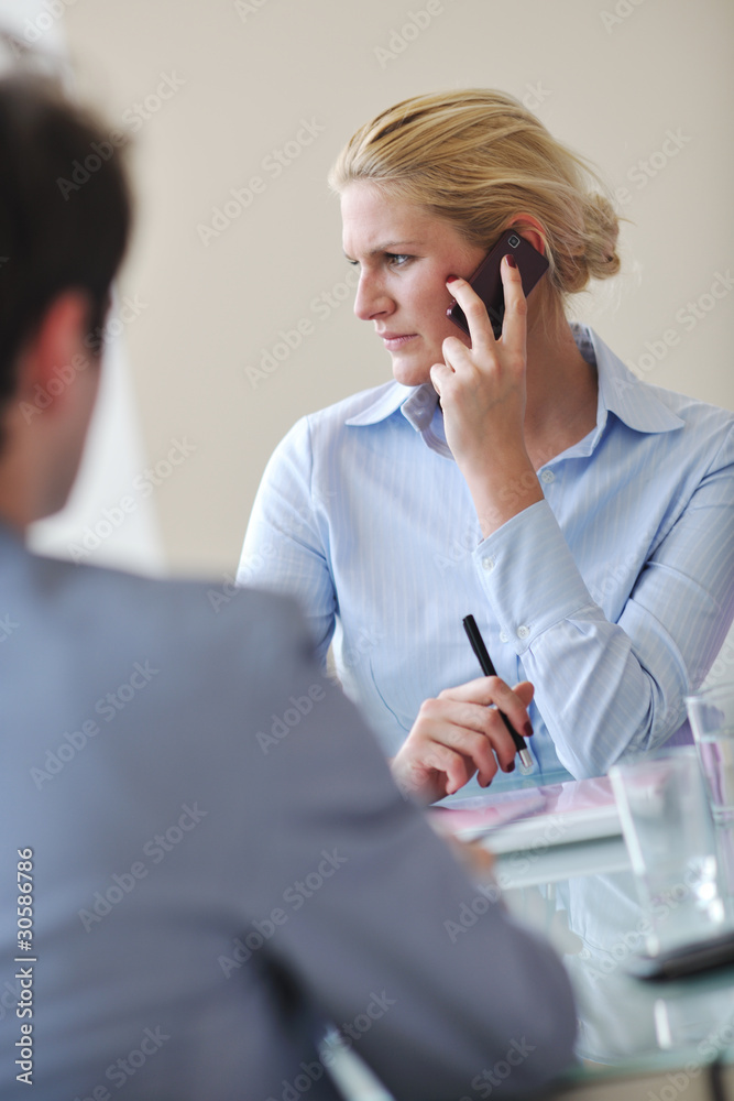 young business woman talk by cellphone on meetng young business woman talk by cellphone on meetng