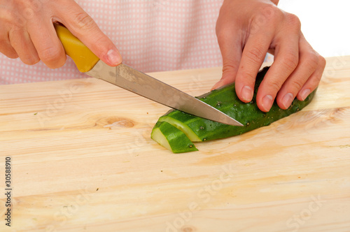 housewife preparing cucumber
