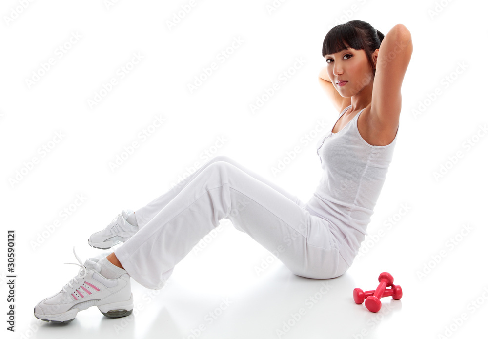 Fototapeta premium Beautiful young woman exercising sit ups