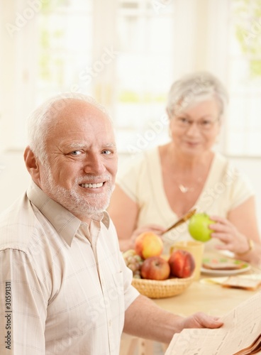 Portrait of older man at kitchen table