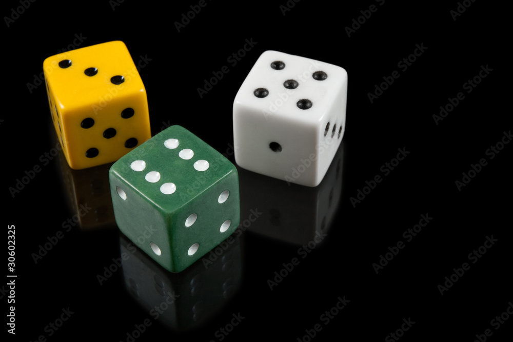 Green, yellow and white dices on black background Green, yellow and white dices on black background