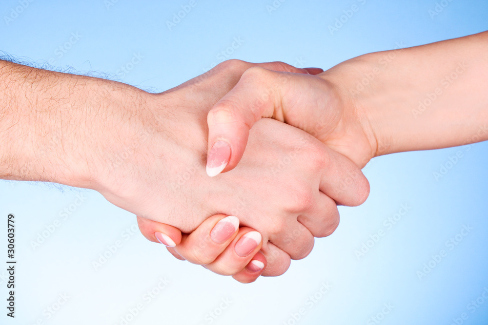 handshake between man and woman on blue background handshake between man and woman on blue background