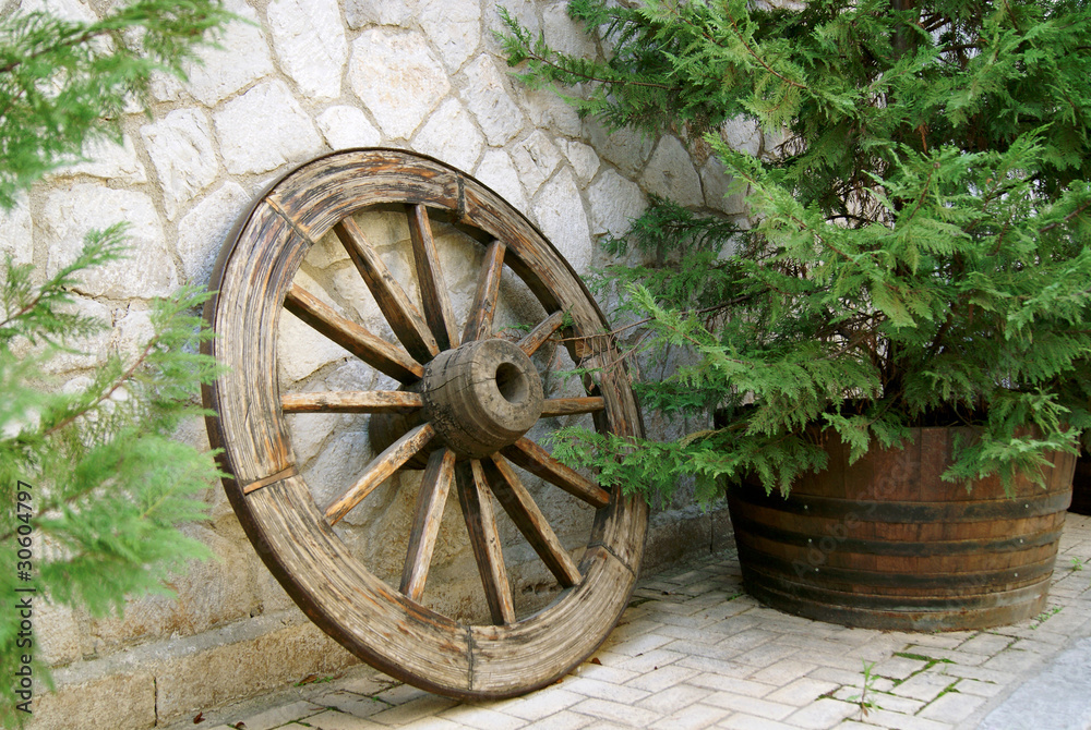 Retro wooden wheel on the pave street