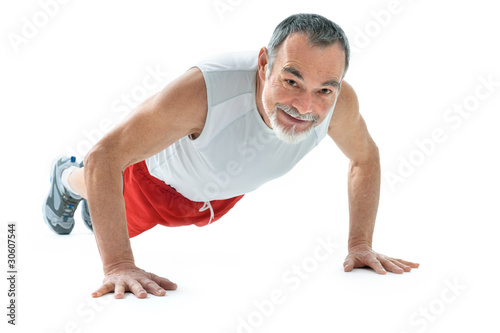 senior man doing push-ups exercise in gym