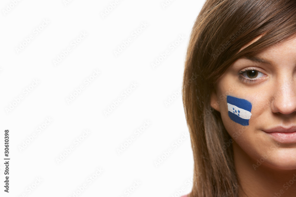 Young Female Sports Fan With Honduras Flag Painted On Face Young Female Sports Fan With Honduras Flag Painted On Face