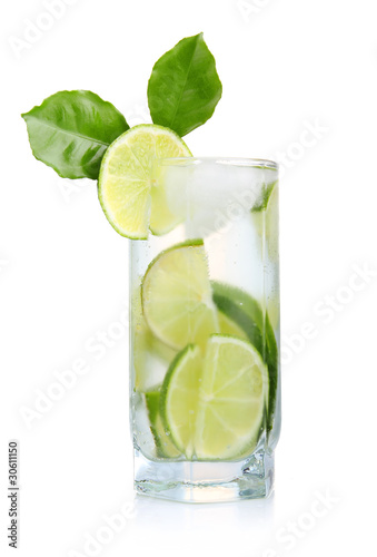 Full glass of fresh cool tonic with lime fruits isolated