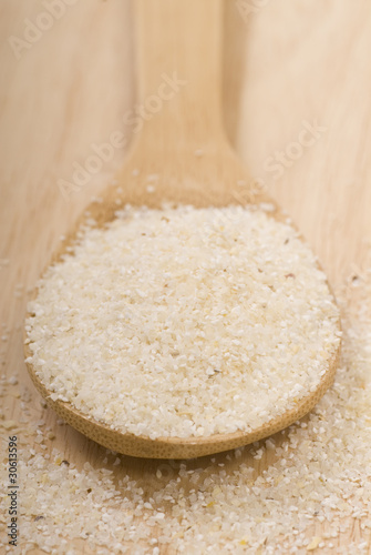 Fresh grits on a wooden spoon