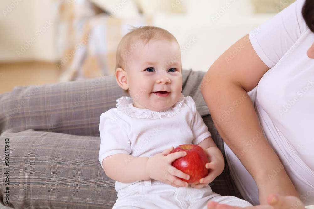 a young mother with her infant baby at home a young mother with her infant baby at home