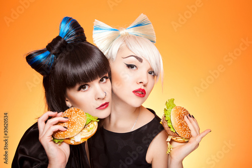 two girls with burgers