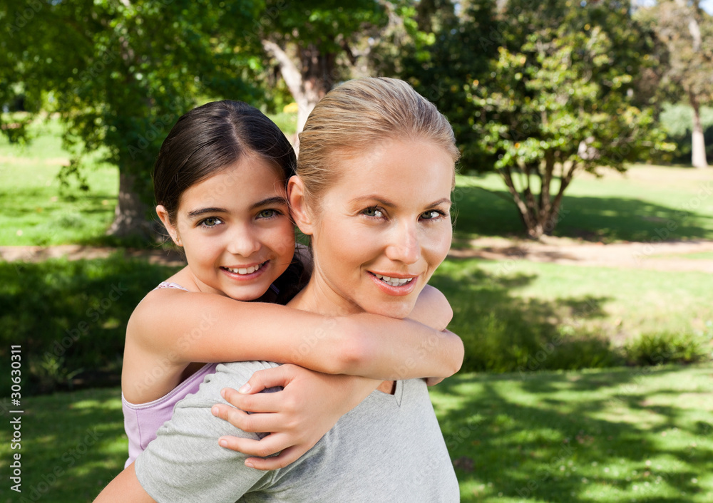 Mother and her daughter laughting in the park Mother and her daughter laughting in the park