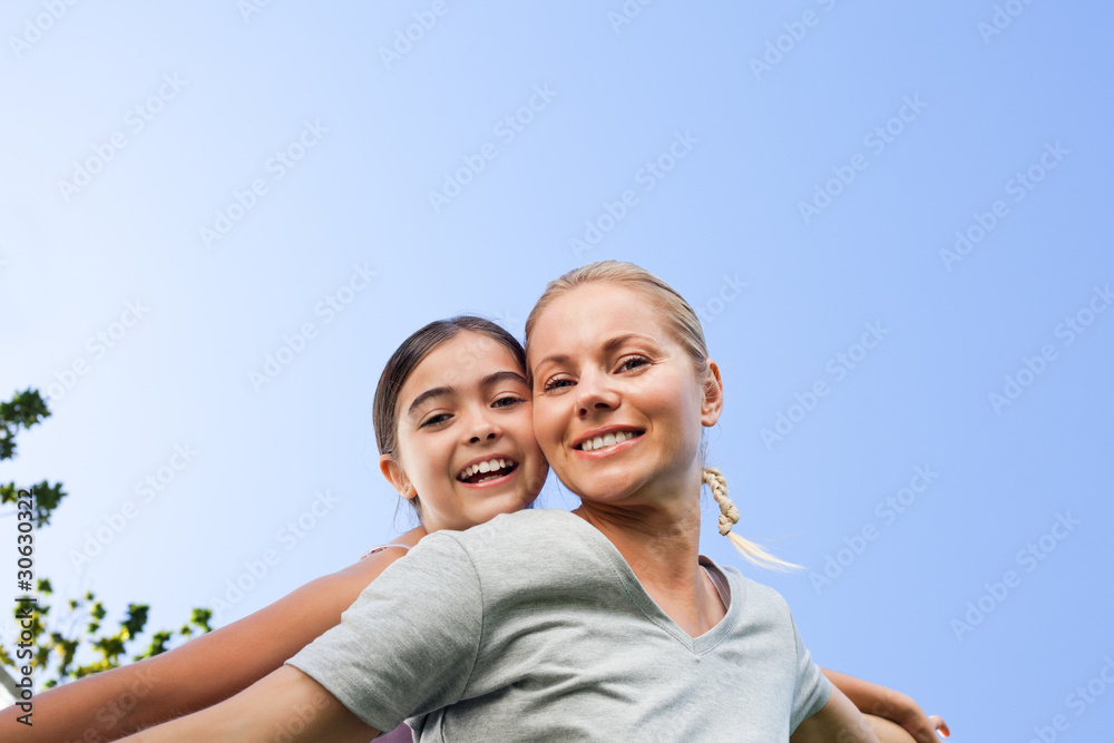 Mother and her daughter laughting in the park Mother and her daughter laughting in the park