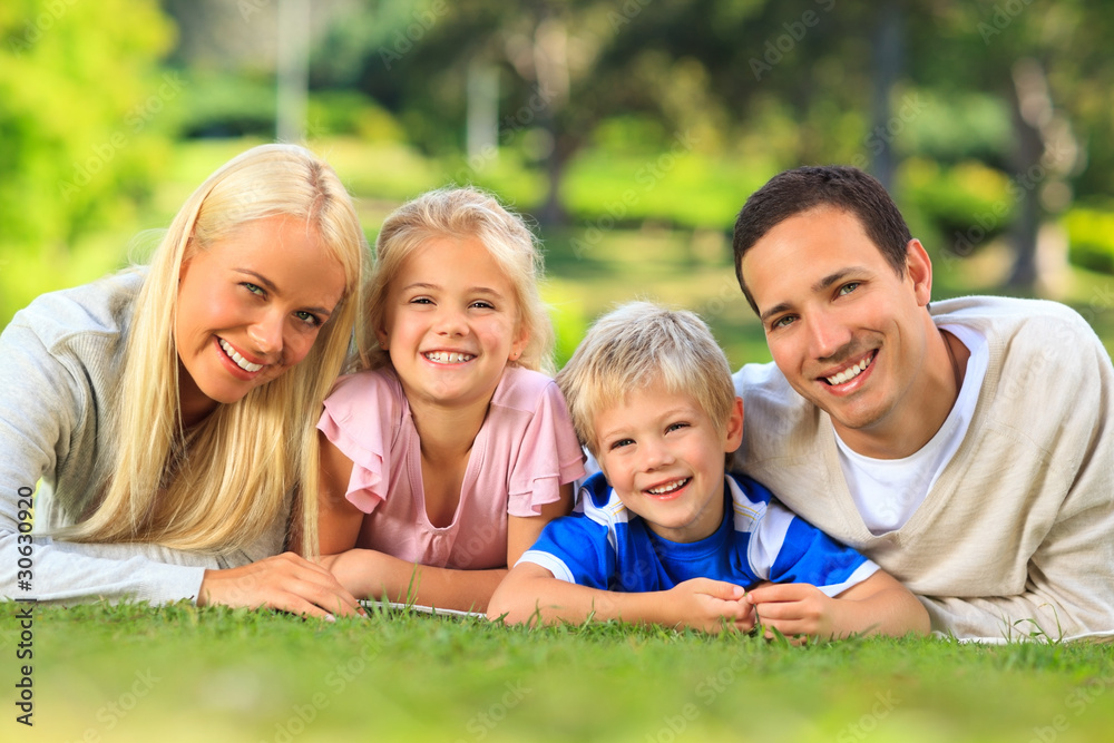 Family lying down in the park Family lying down in the park