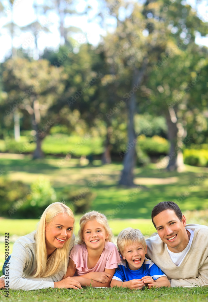 Family lying down in the park Family lying down in the park